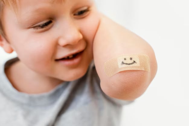 Joyful Child with Bandage on Elbow