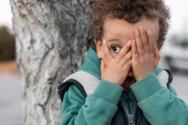 A Child Hiding Behind Hands