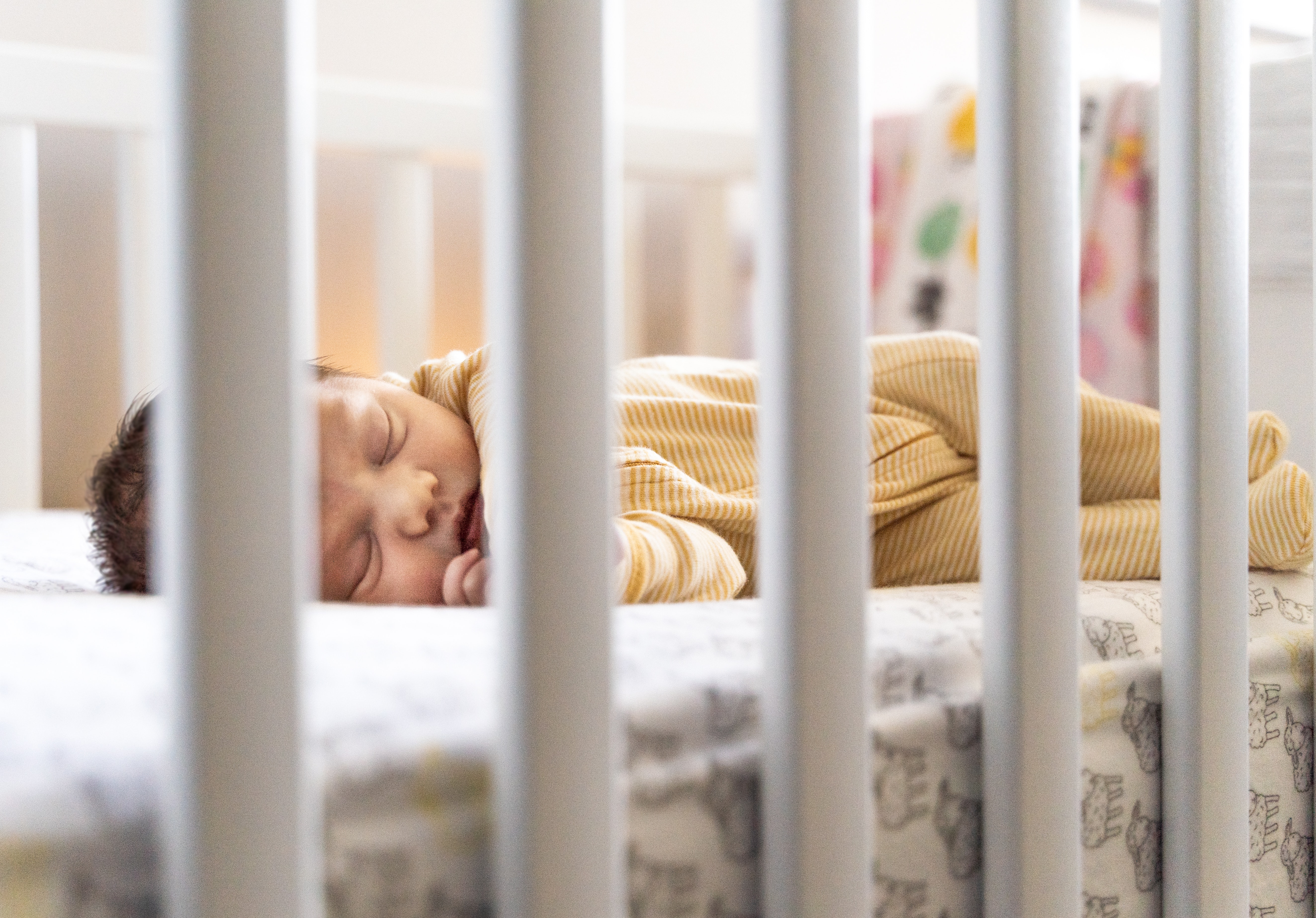 Peaceful Slumber Behind Crib Bars