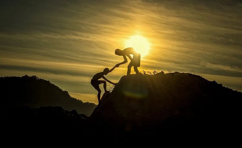 Silhouetted Figures Climbing Towards The Sun image in article How a Positive Classroom Changes Everything